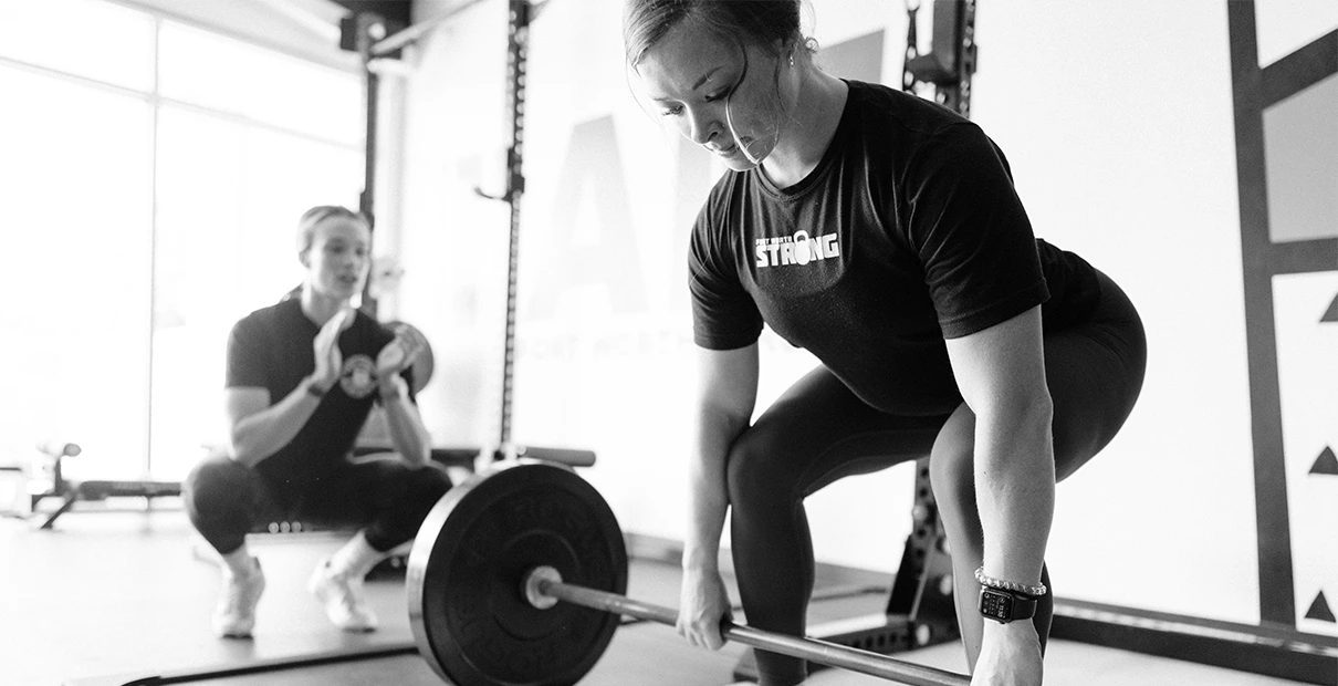 woman lifting weights at Fort Worth Strong